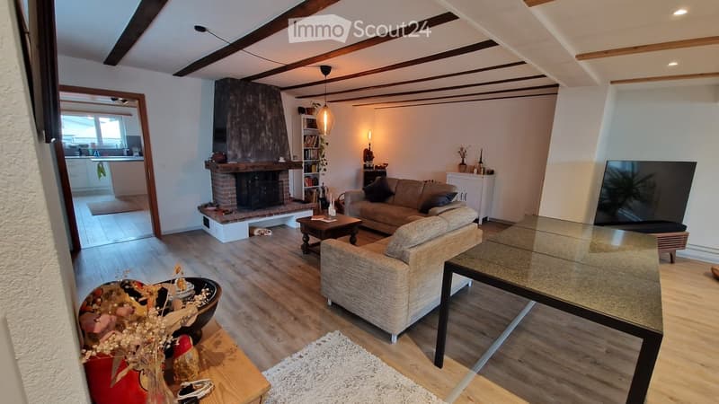 wooden floor, fireplace, couch, coffee table, TV, rug, wooden table
