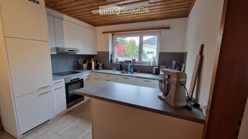 modern kitchen, white cabinets, wooden floor, gas stove, oven, dishwasher, washing machine, mixer, sink, window