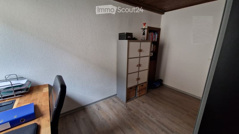 wooden floor, white walls, desk, chair, storage cabinet, bookshelf, candle holder, books, basket