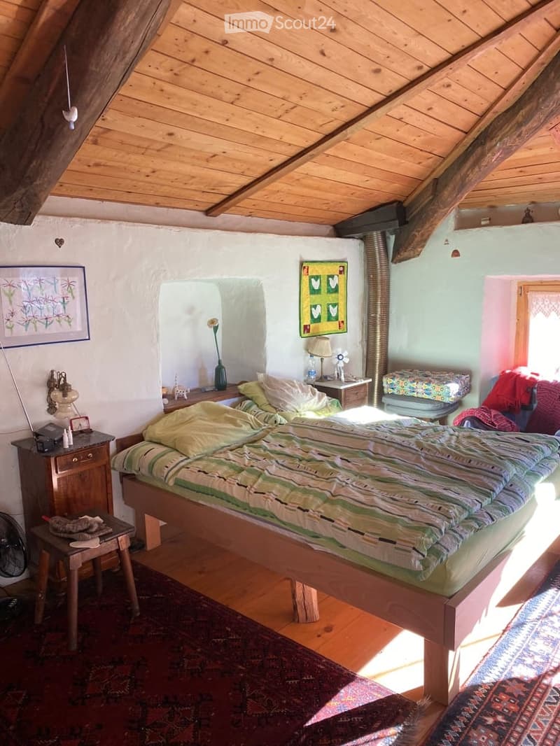 bedroom with wooden bed, wooden nightstands, wooden table, wooden stool, carpet, wooden ceiling, wall art, lamp, fan, window
