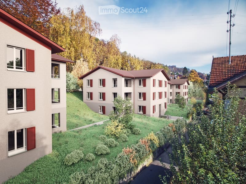 A multi-story residential building with red shutters and a sloped roof, surrounded by greenery and trees.