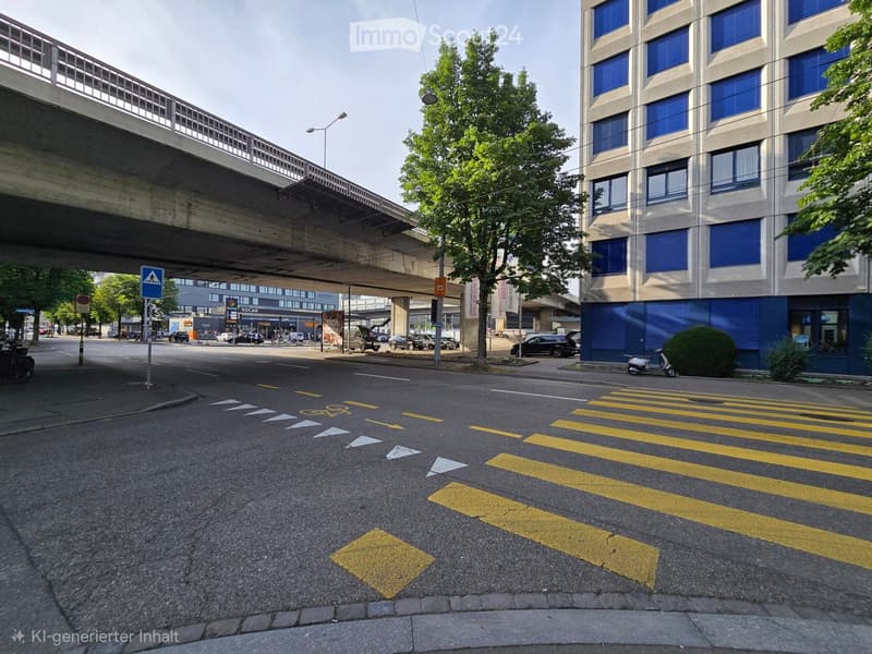 Multi-story building with blue windows and shutters, located near a road crossing with pedestrian crossing and traffic signs.