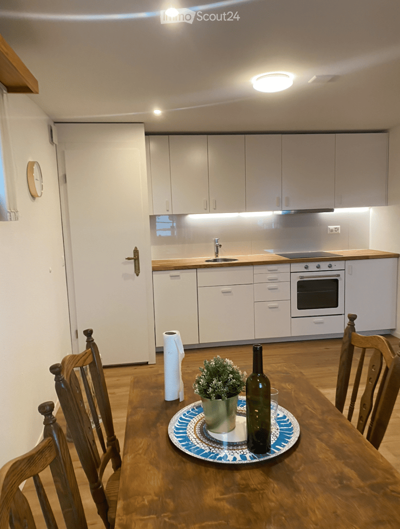 modern kitchen with wooden floor, white cabinets, wooden countertops, stainless steel sink, white appliances, window, clock