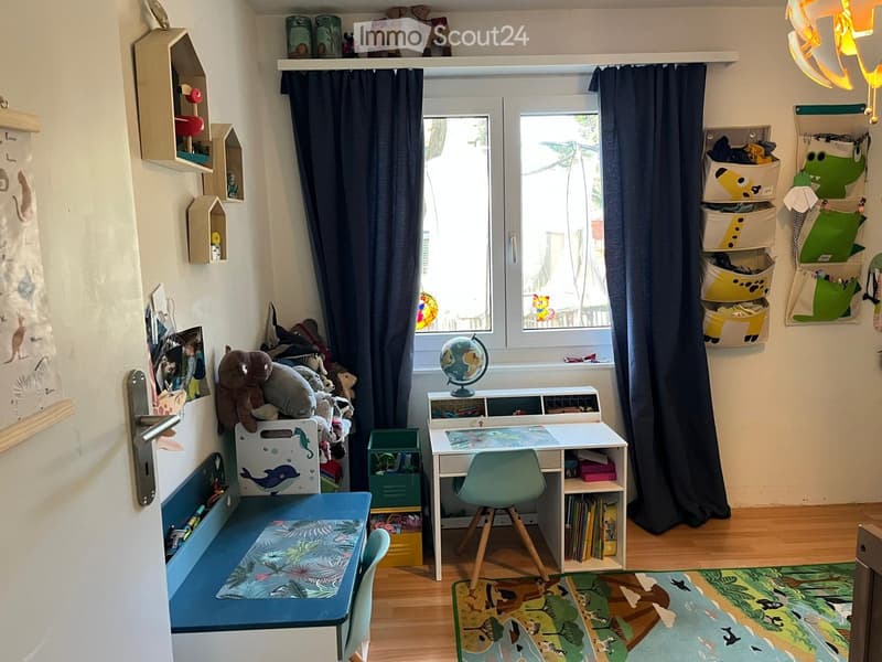 A well-organized children's bedroom with a desk, chair, bench, globe, storage bins, shelves, and toys.
