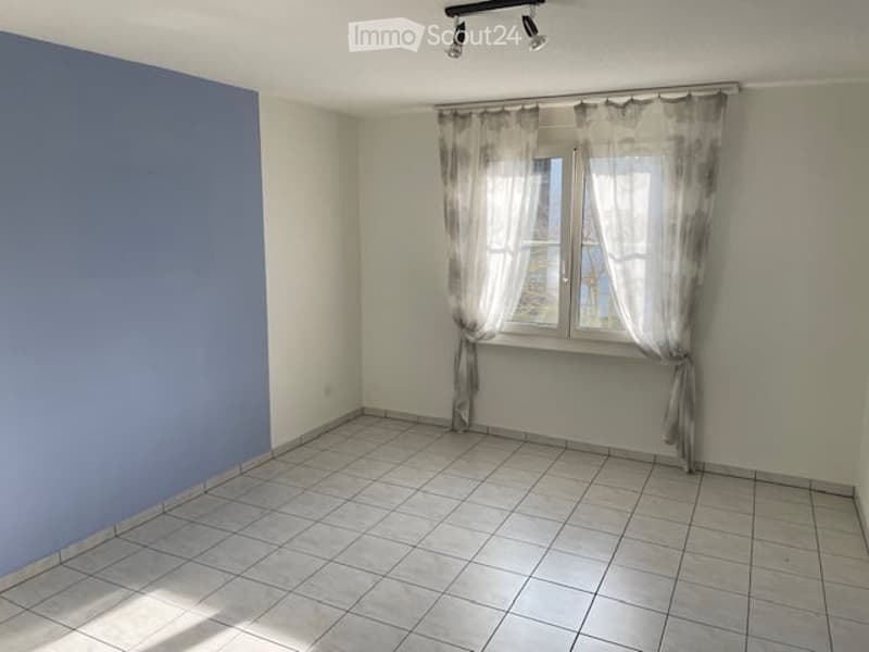 empty room, white tiles, blue wall, window with curtains, ceiling lights