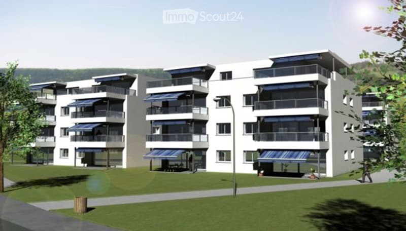 Modern multi-story residential building with balconies, large windows, and a landscaped lawn area in front.