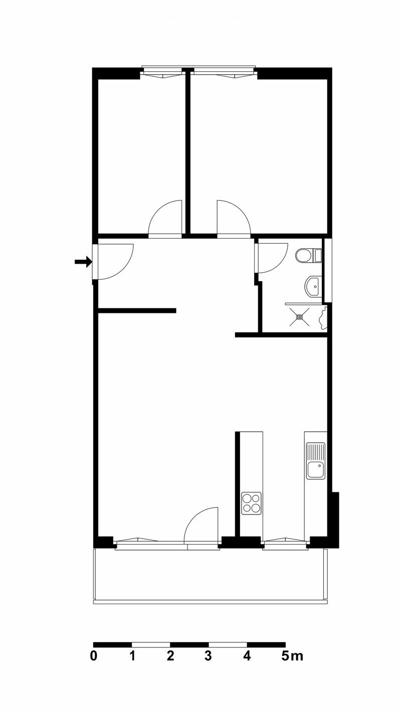 Layout of a compact studio apartment featuring a combined living and sleeping area, a kitchenette, and a bathroom with a toilet and shower.