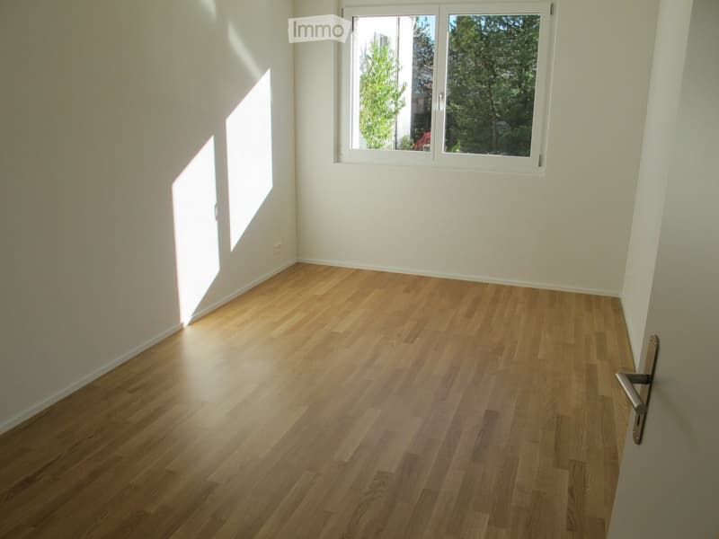 wooden floor, window, white walls, corner of the room
