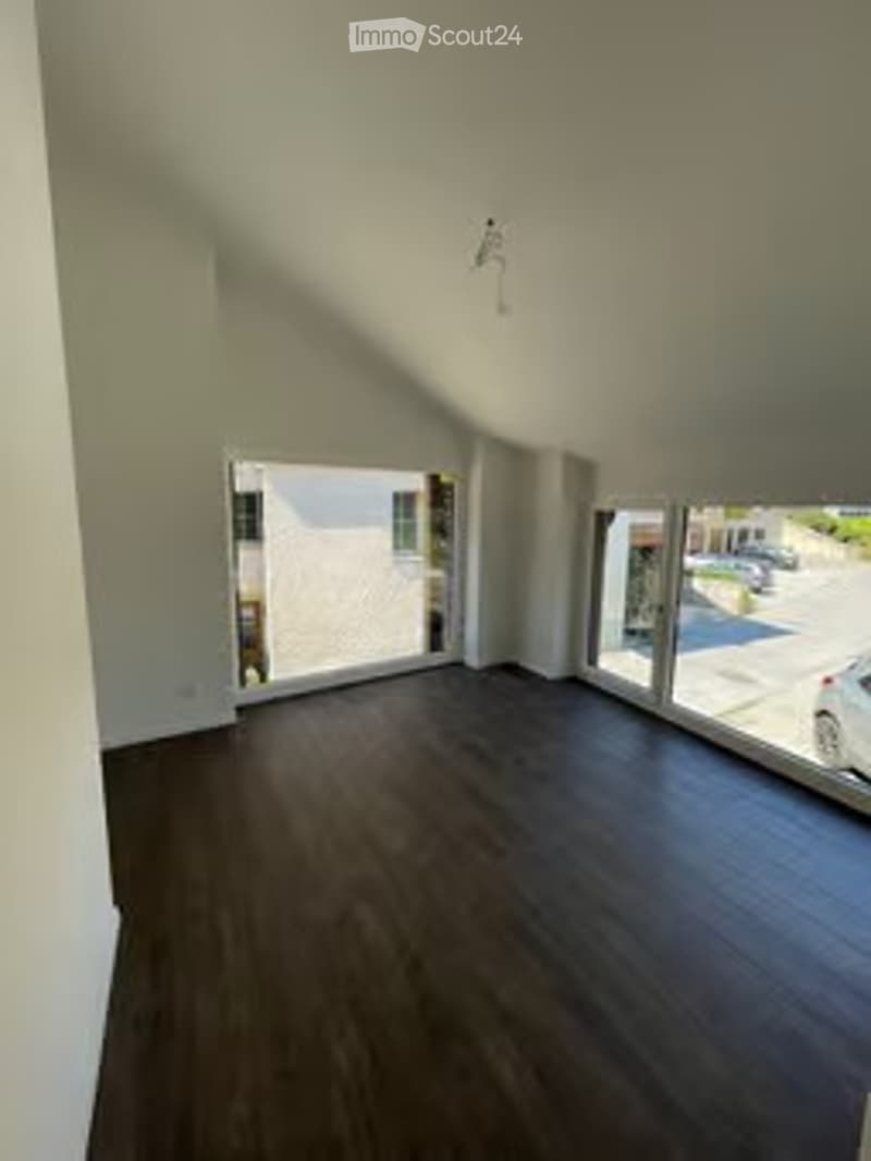 Completely empty room with bare walls and wooden floor. No furniture or equipment.