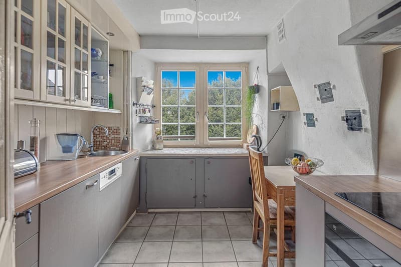 kitchen with wooden countertops, gray cabinets, dishwasher, washing machine, sink, window, wooden table, wooden chair, stove, oven