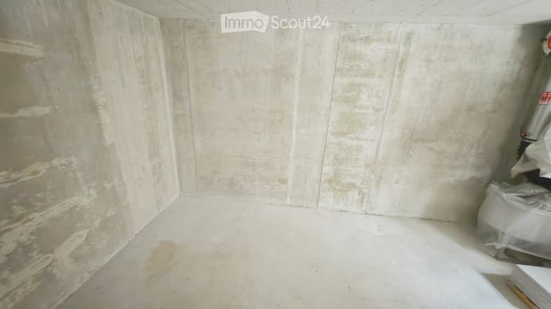 Empty room with bare concrete walls and floor, no furniture or equipment visible.