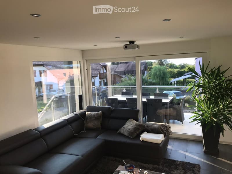 black leather sofa, glass doors, balcony, projector, dining table, chairs, garden view