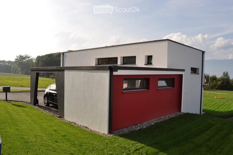 modern house, white and red exterior, car in garage, large windows, green lawn