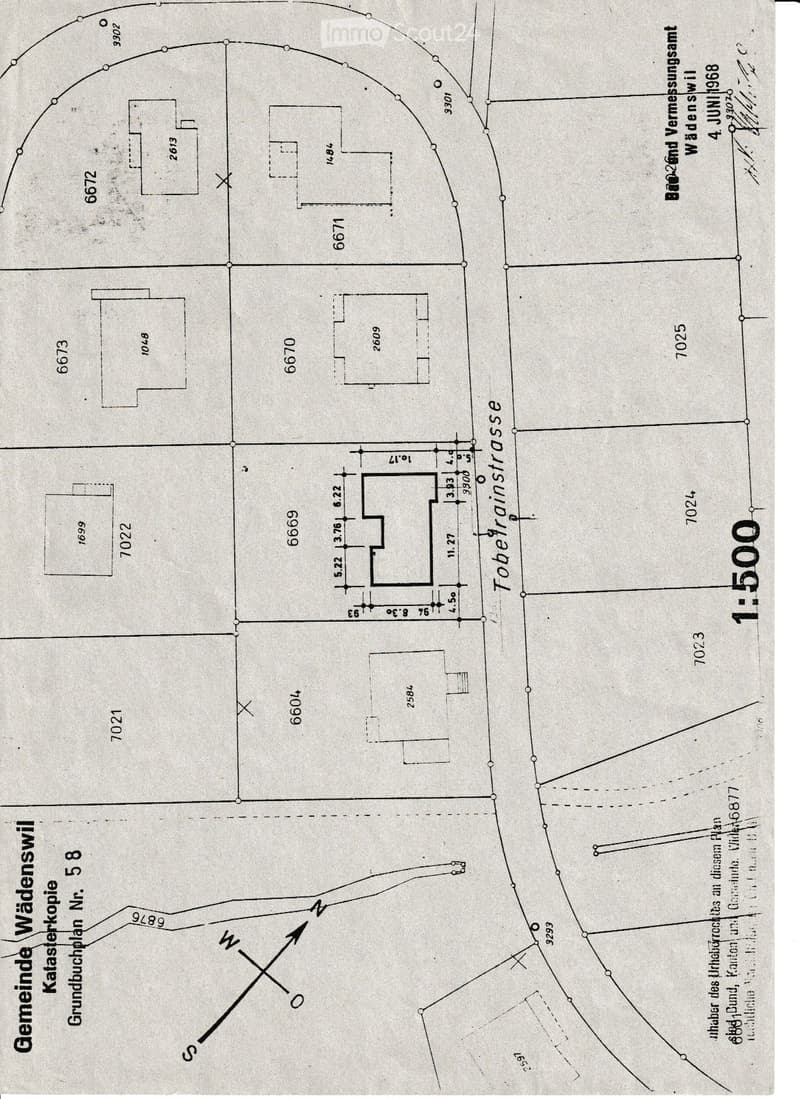 Ground plan of a property showing various labeled areas and measurements, including a central rectangular space and surrounding structures.