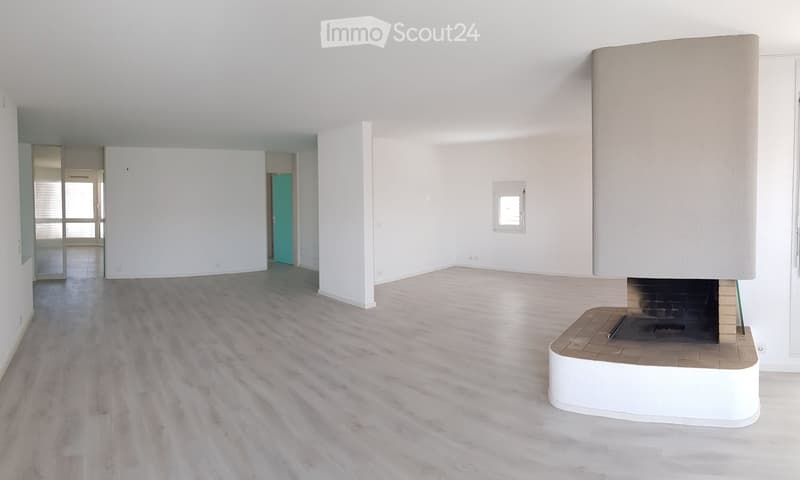 Empty room with white walls, light wooden flooring, and a fireplace with a white mantle. No furniture or equipment is present.
