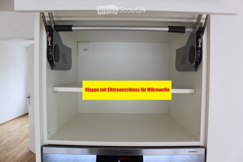 Open cabinet with microwave and shelves, featuring a pull-out mechanism and modern design.