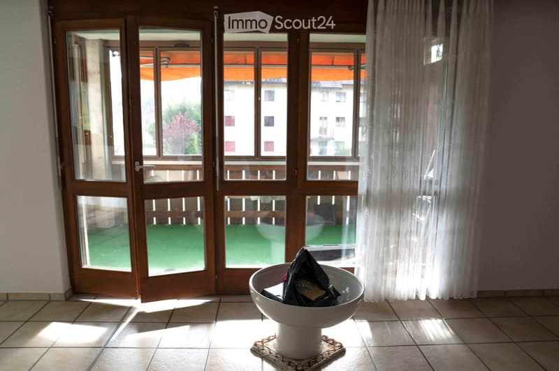 large windows with balcony, white tile floor, white curtain, sun's rays on the floor