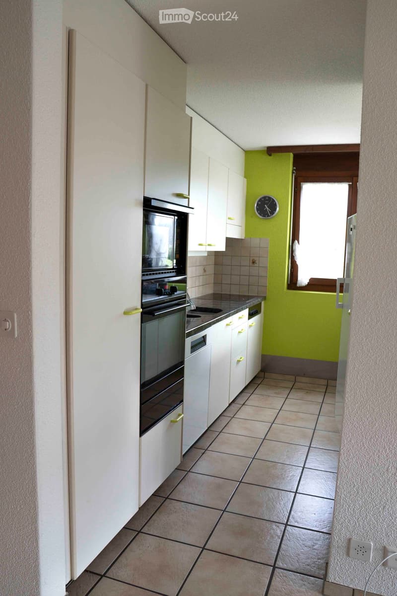 modern kitchen with white cabinets, tiled floor, appliances such as a dishwasher, oven, microwave, refrigerator, electric hob