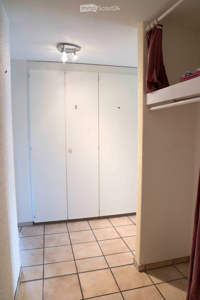 empty room, double closet, tiled floor, white ceiling with light
