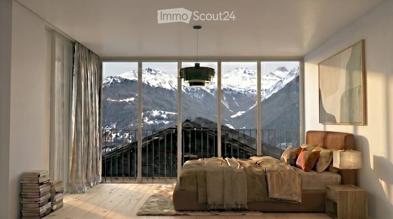 Modern bedroom with large windows offering a scenic mountain view, featuring a bed with pillows and blankets, a nightstand with a lamp, a mirror, and a stack of books near the window.