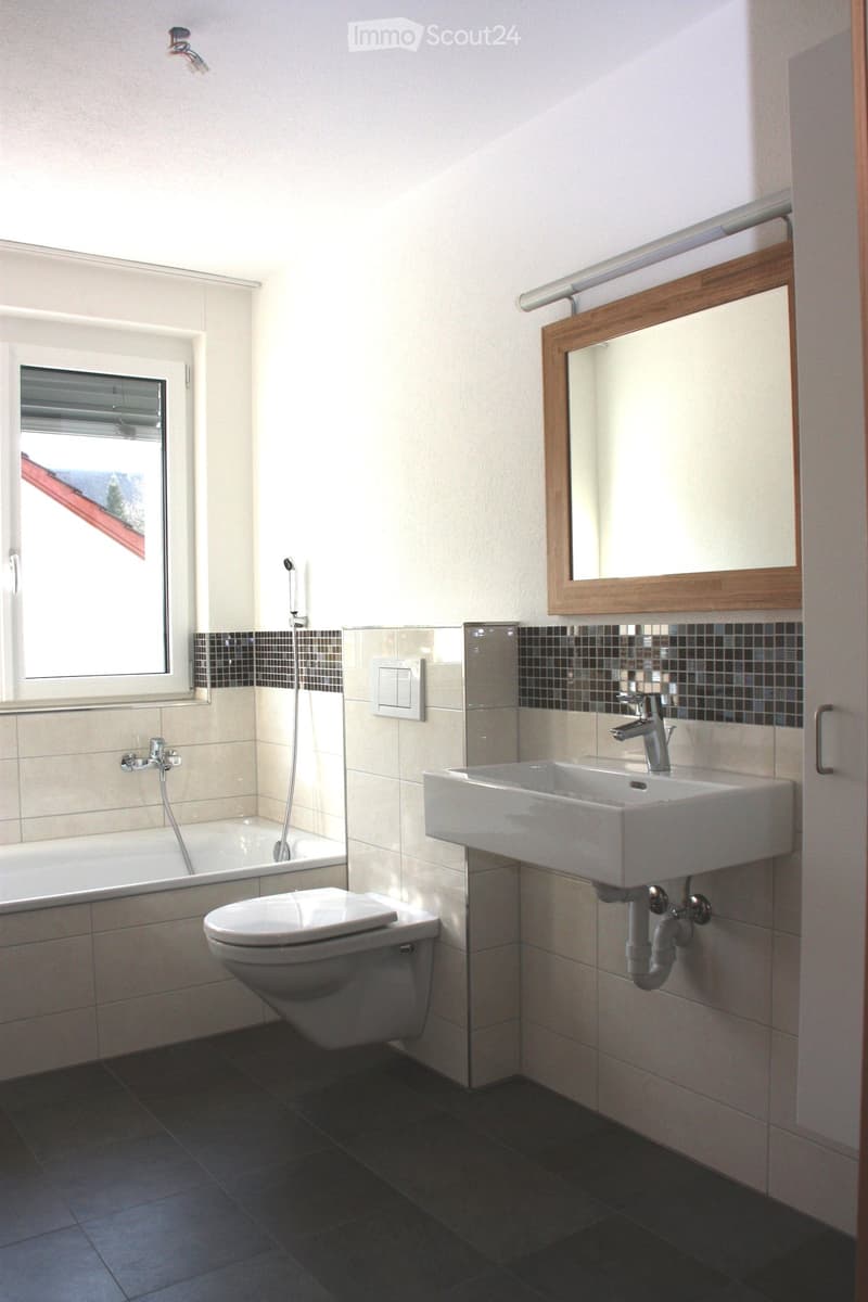 White bathtub, shower area, white toilet, white sink, mirror