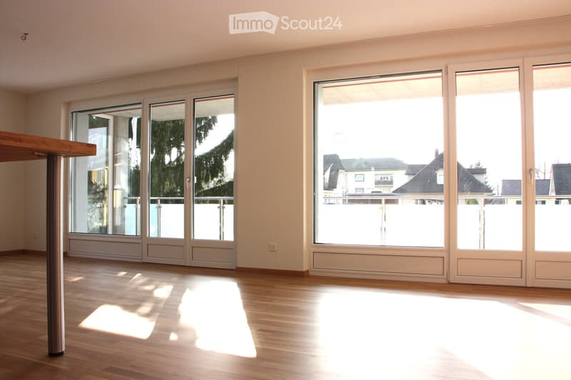 empty room with sliding doors leading to balcony, wooden floor