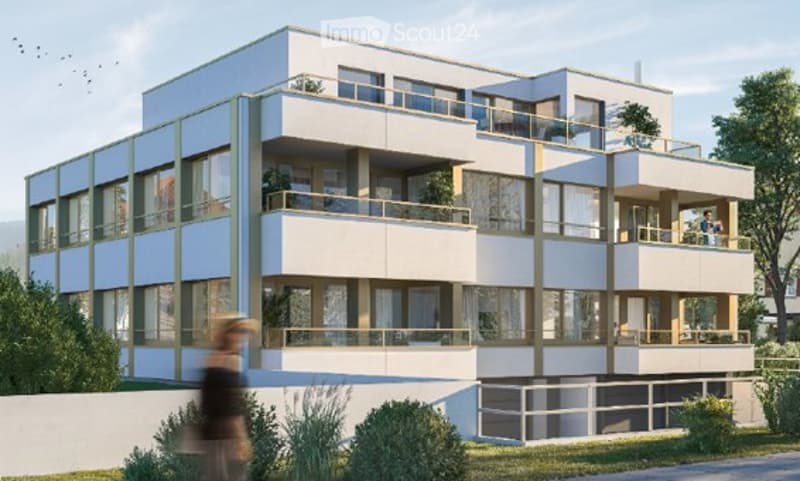 Modern multi-story apartment building with large windows, balconies, and contemporary design.