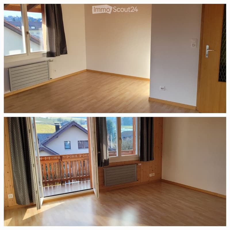 Empty room with wooden flooring, large windows, radiator, and a door leading to a balcony with wooden railing.
