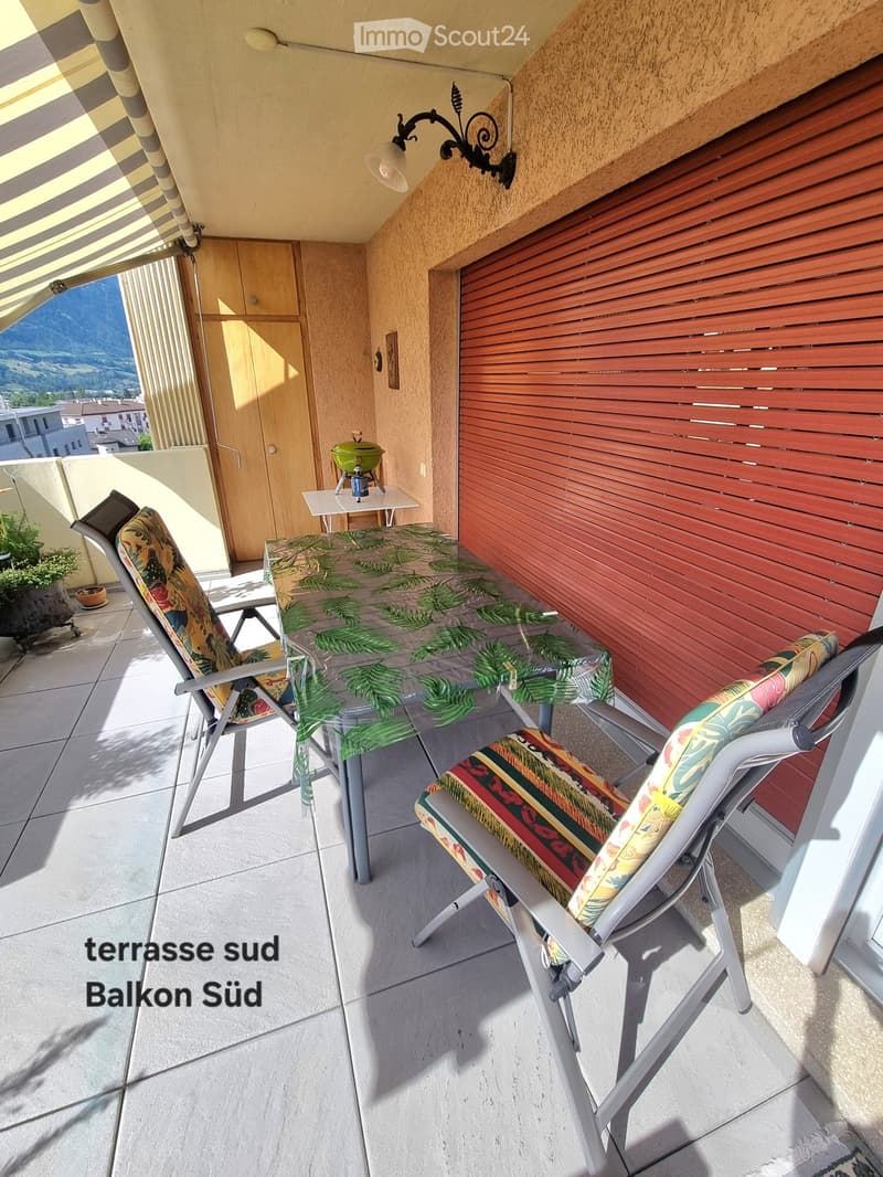 balcony with table and chairs, awning, red shutter, small table with grill, plants