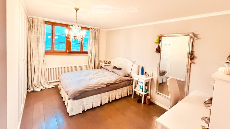 bedroom, double bed, nightstand with drawers, large mirror, chandelier, white curtains, wooden floor, radiator