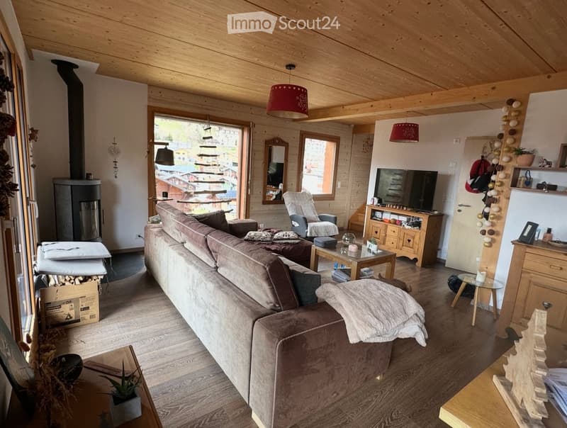 wooden ceiling, fireplace, large windows, couch, coffee table, TV, wooden floor