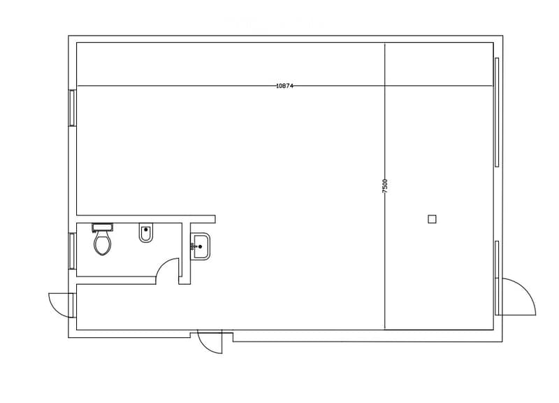Floor plan of a small studio apartment with a separate bathroom area. The main space is open, and the bathroom includes a toilet, sink, and shower.
