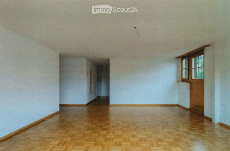 Completely empty room with wooden flooring and white walls. No furniture or equipment visible.