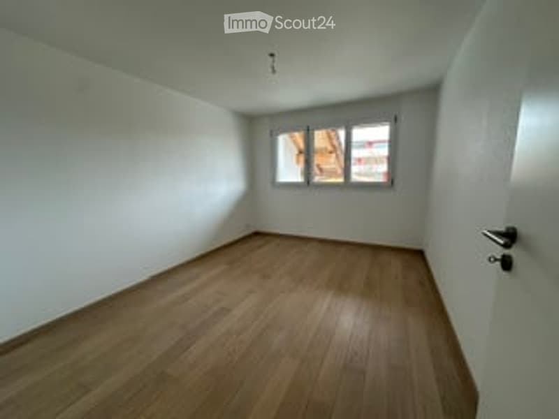 Completely empty room with bare white walls and wooden floor. No furniture or equipment.