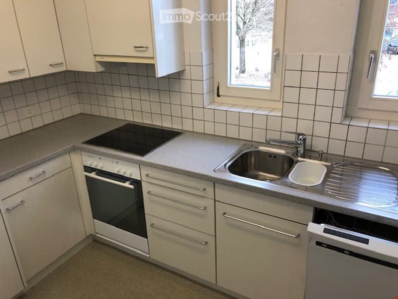 modern fitted kitchen with white cabinets, tile flooring, electric stove, oven, dishwasher, sink, windows