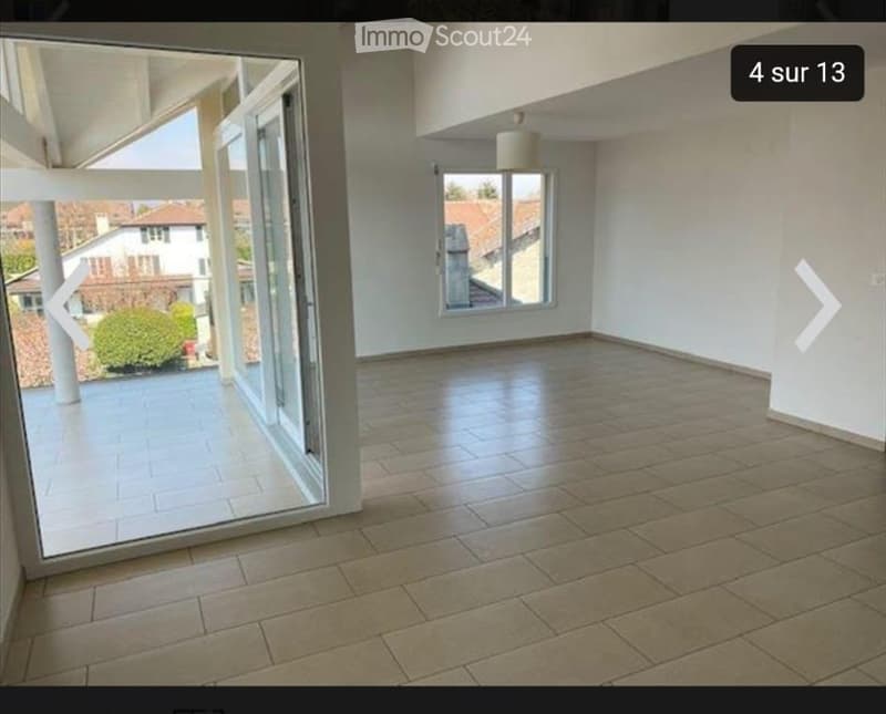 Empty room with tiled floor, large windows, and a view of the outside area.