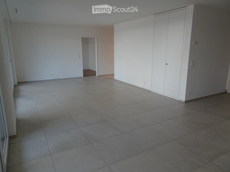 Empty room with tiled floor, white walls, and built-in white cabinetry. No furniture or equipment present.