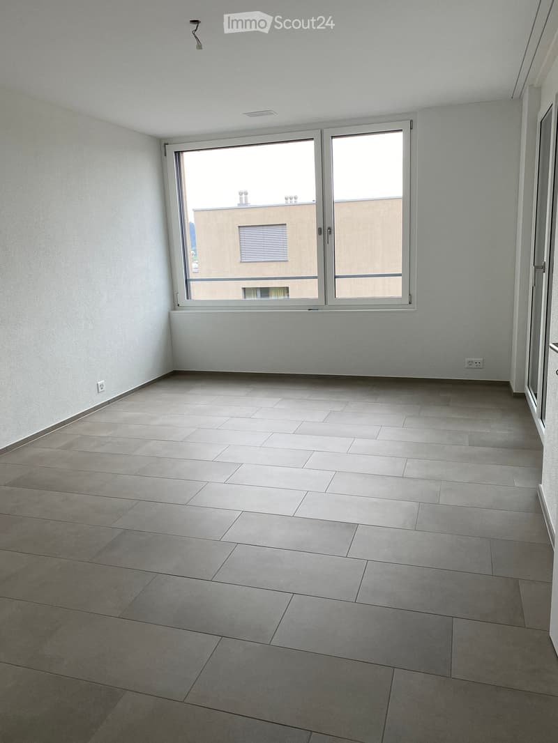 empty room, white walls, tiled floor, large window, power outlets