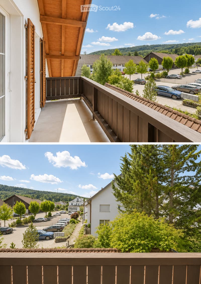 Balcony with wooden railing and wooden shutters, overlooking a parking lot and surrounding greenery.