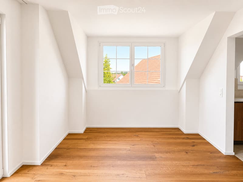 Completely empty room with white walls and wooden floor. No furniture or equipment.