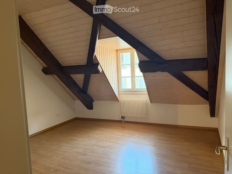 empty room, wooden floor, wooden beams, white walls, window, radiator