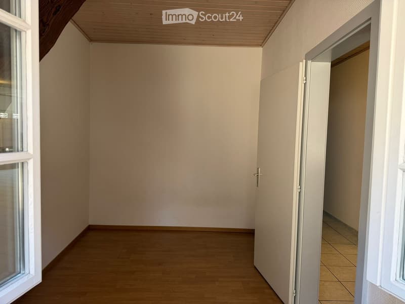 empty room, wooden floor, white walls, two windows, open door