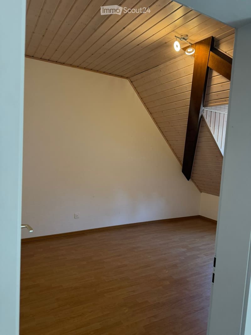 empty room, wooden floor, white walls, wooden ceiling, slanted ceiling, power outlet