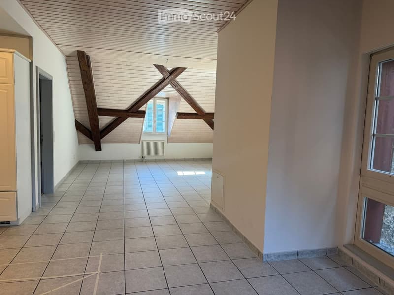 empty room, wooden ceiling, tiled floor, white walls, window with blue shutters