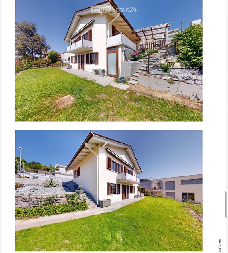 Two-story house with white exterior, brown shutters, and a balcony. The house is surrounded by a well-maintained lawn and stone steps leading to the entrance.