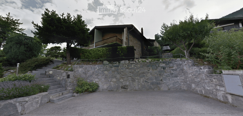 House on a hill, stone wall, steps, trees, shrubs, driveway