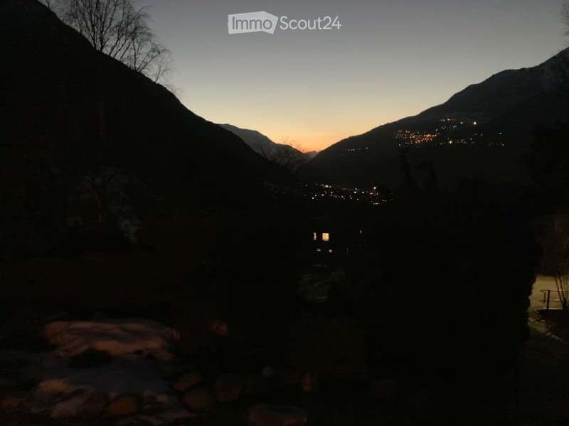 Mountain view, sunset, house in the distance, trees, rocks