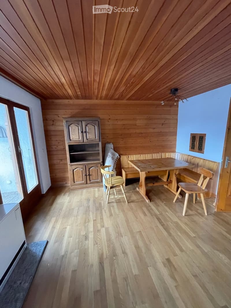 wooden floor, wooden walls, wooden table, wooden chairs, wooden cabinet, glass door, radiator
