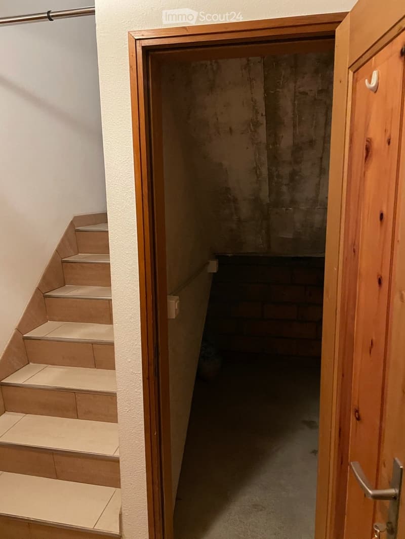 wooden staircase, white tiles, wooden door, brick wall