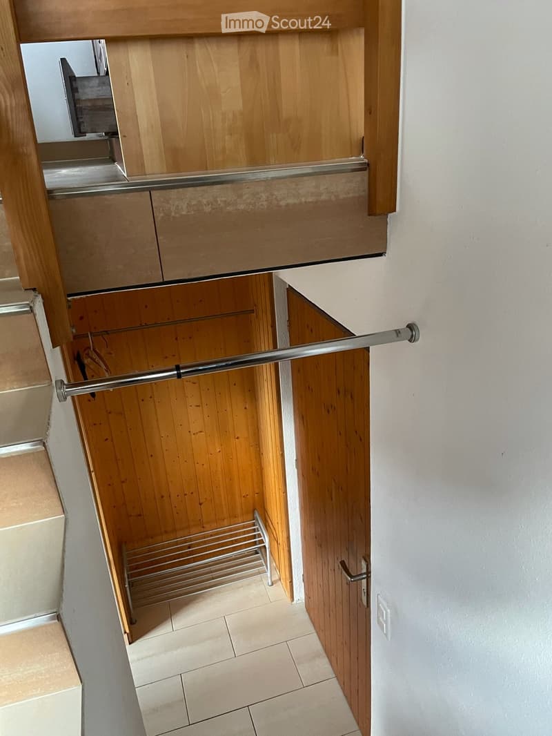 wooden stairs, wooden door, metal rod, tiled floor